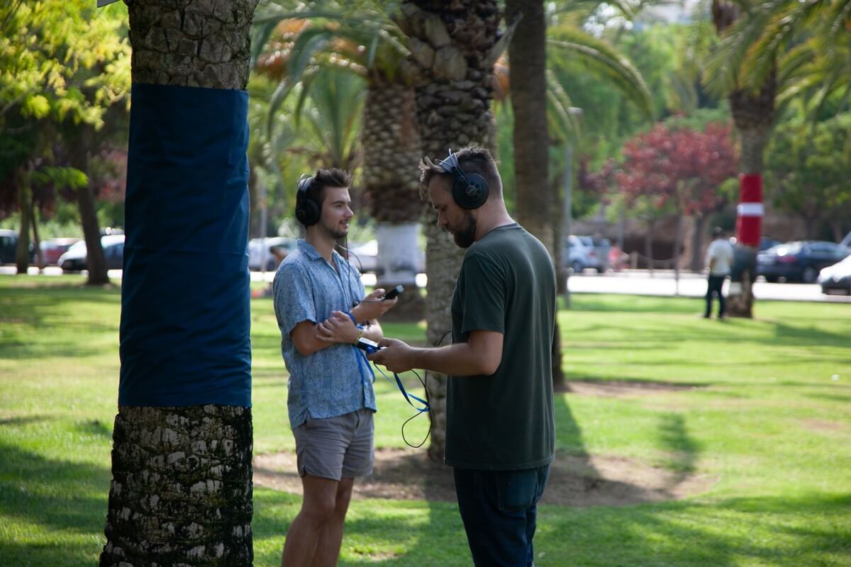 Two people with headphones participating in Alluvial Sharawadji